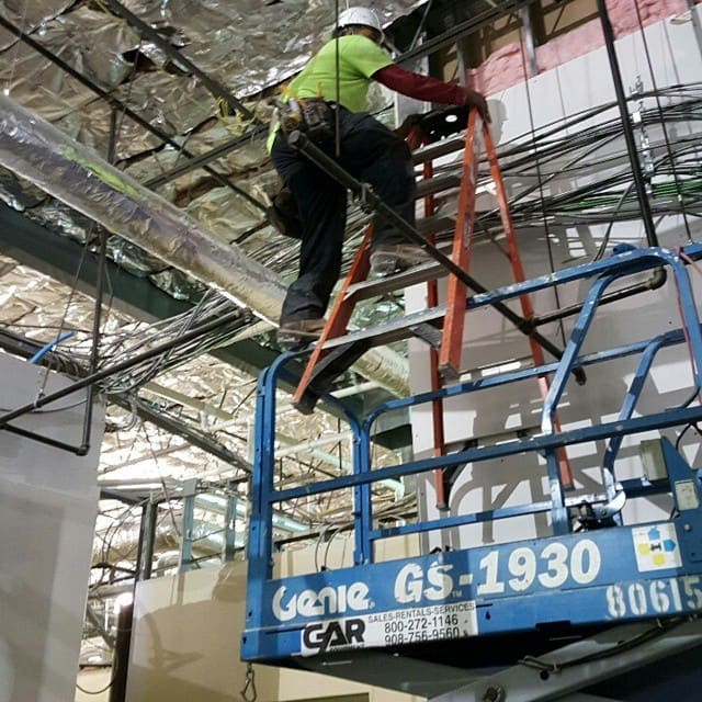 Contractors working unsafely on ladders.