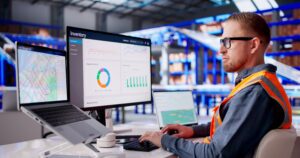 Warehouse,supervisor,monitors,digital,systems,to,manage,automated,logistics,operations